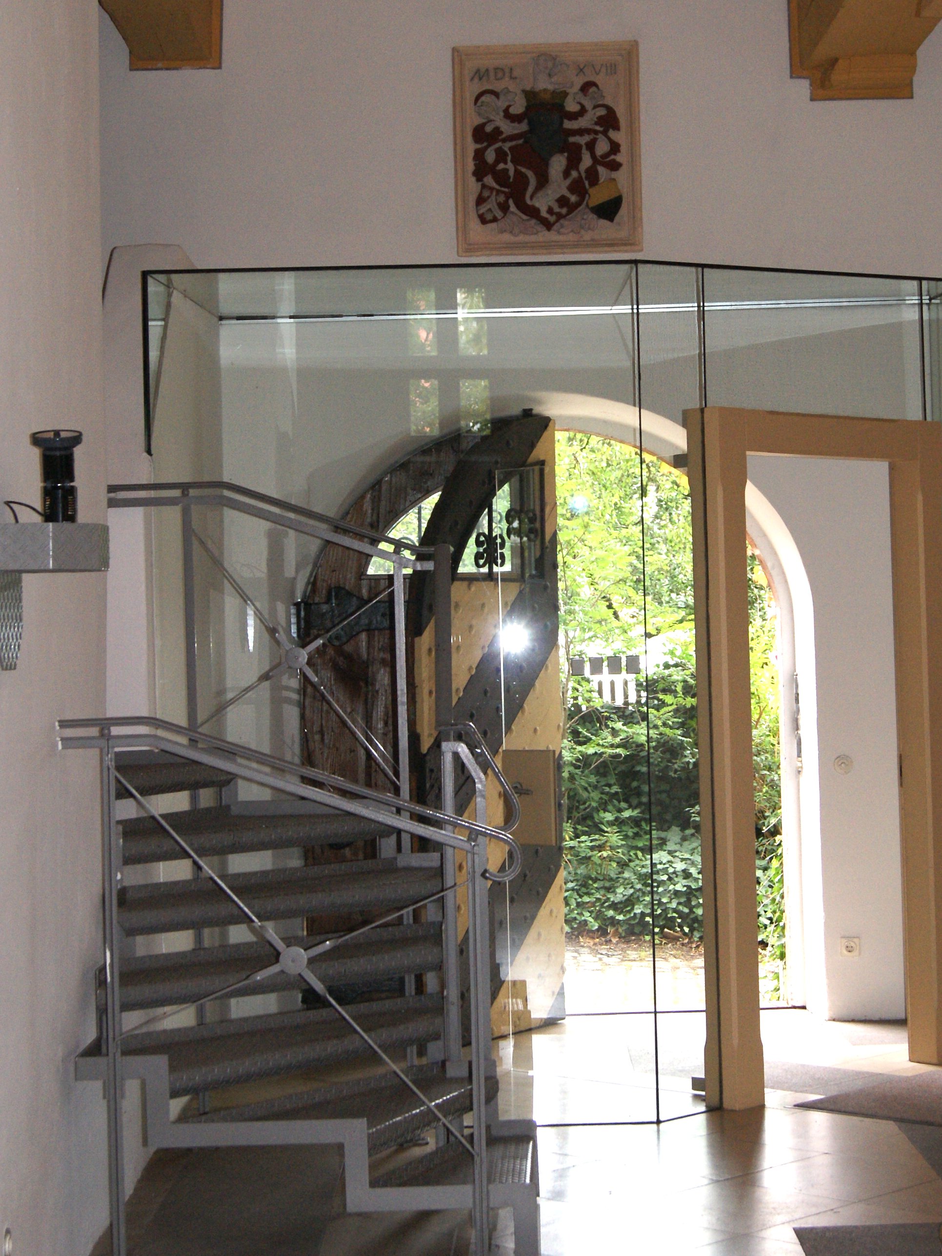 Entrance area Patrician Manor of the Pfinzing Family with glass door and coat of arms
