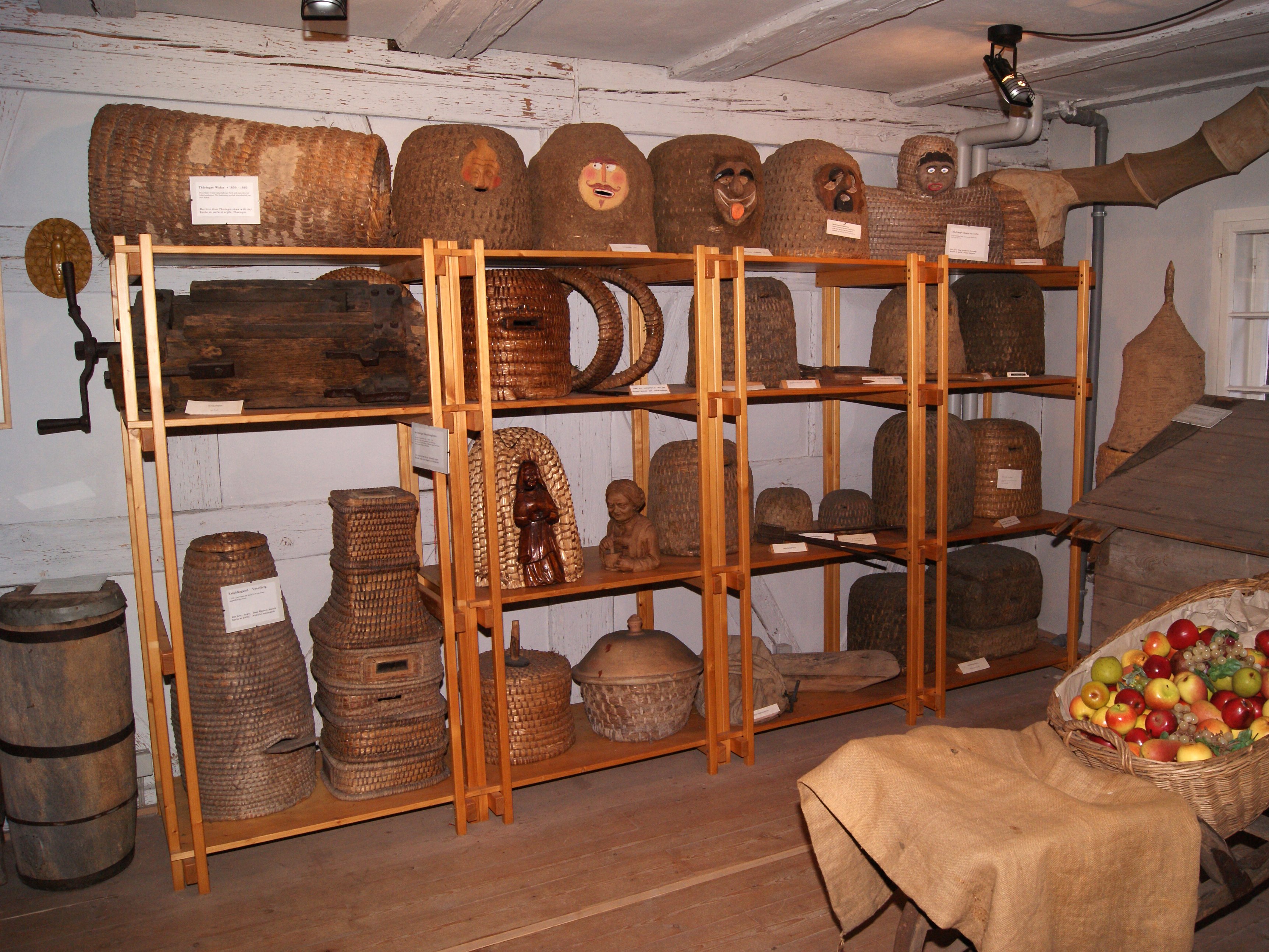 The picture shows various beehives in the Apiculturists Museum